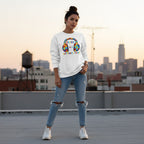 Latina woman wearing a white "Rockin' to a Different Tune" autism awareness sweatshirt.