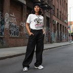 Latina woman in streetwear posing outdoors wearing a white t-shirt