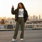 Latina woman wearing a white t-shirt and posing in an urban streetwear setting