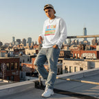 Latino man wearing a white autism awareness sweatshirt with a retro design featuring the words accept, understand, love, and different.