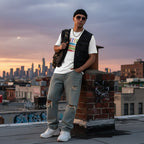 Latino man wearing a white autism awareness T-shirt in a streetwear style.