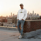 Latino man wearing a white heartbeat puzzle sweatshirt.