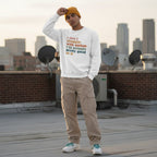 Latino man wearing a white autism awareness sweatshirt.