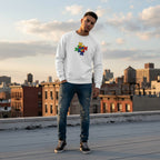 Latino man wearing a white autism awareness sweatshirt with a puzzle heart logo.