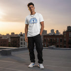 Latino man wearing a white autism awareness t-shirt.