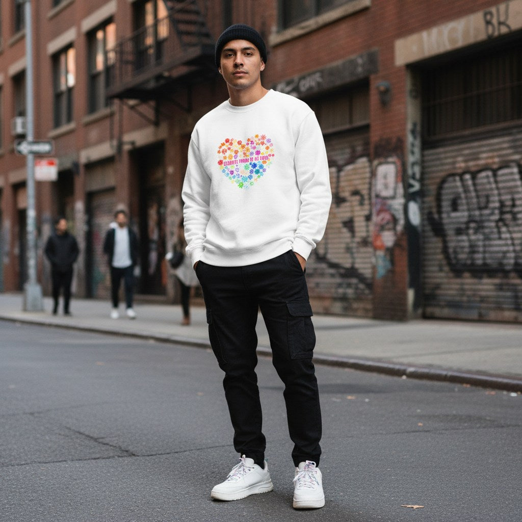 Latino man wearing a white Celebrate Minds floral heart sweatshirt.