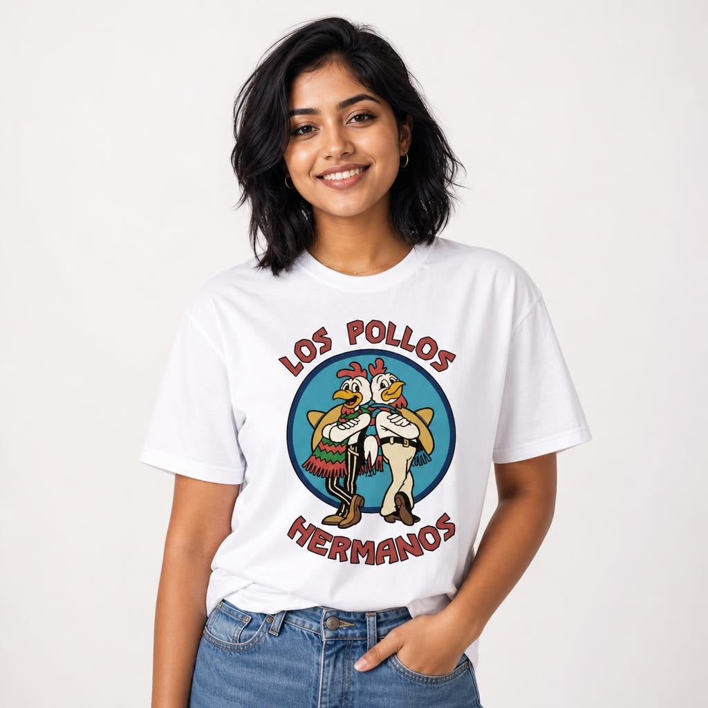 Model wearing a White T-Shirt featuring two cartoon chickens in western-style clothing inside a blue emblem with Los Pollos Hermanos lettering.