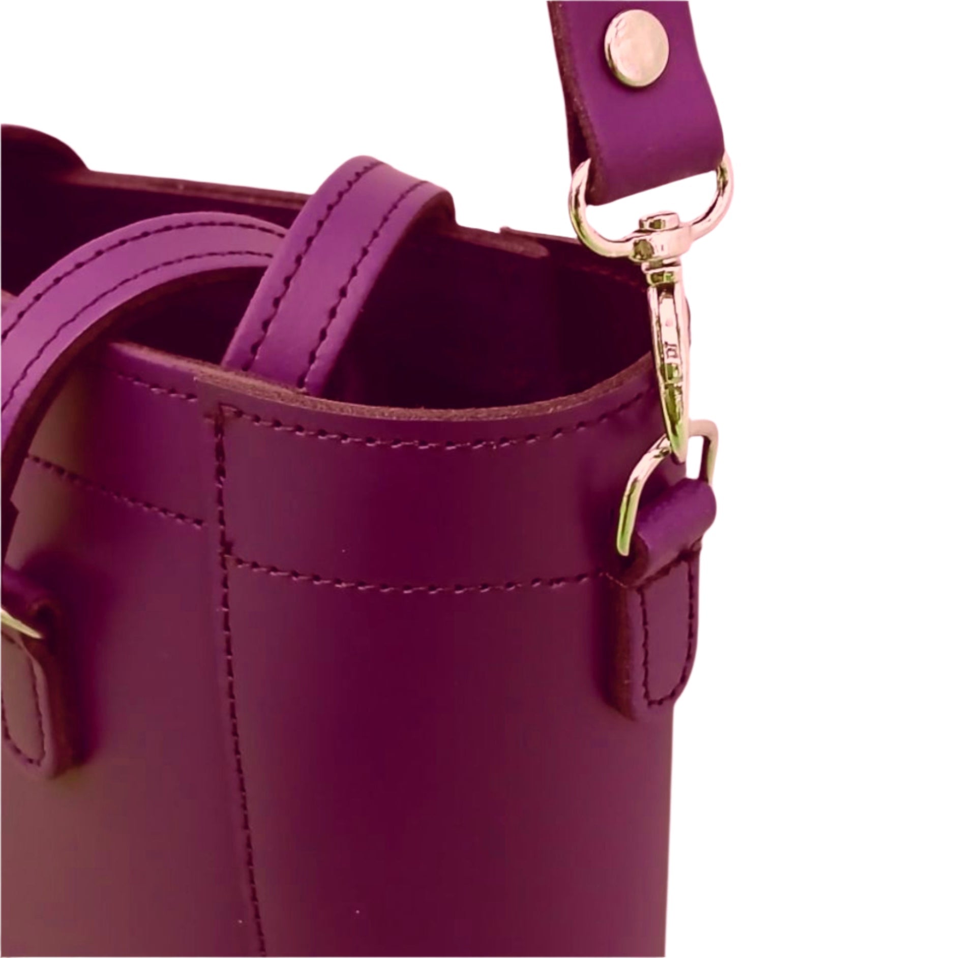 Close-up of a purple handbag with a gold clasp on a white background