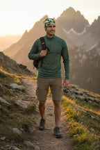 Man hiking on a mountain trail with mountains in the background