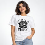 Model wearing a white T-shirt with a black-and-white cat in a cowboy hat and the word “MEOWDY.”
