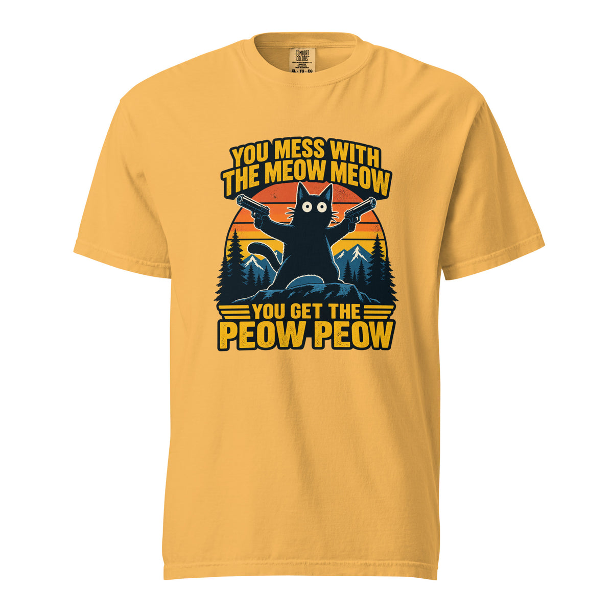 Front view of a mustard T-shirt featuring a black cat holding two pistols before a striped sunset, mountains, and pine trees.