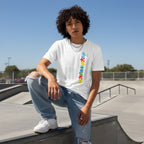 Middle Eastern non-binary person wearing a white autism flag T-shirt.