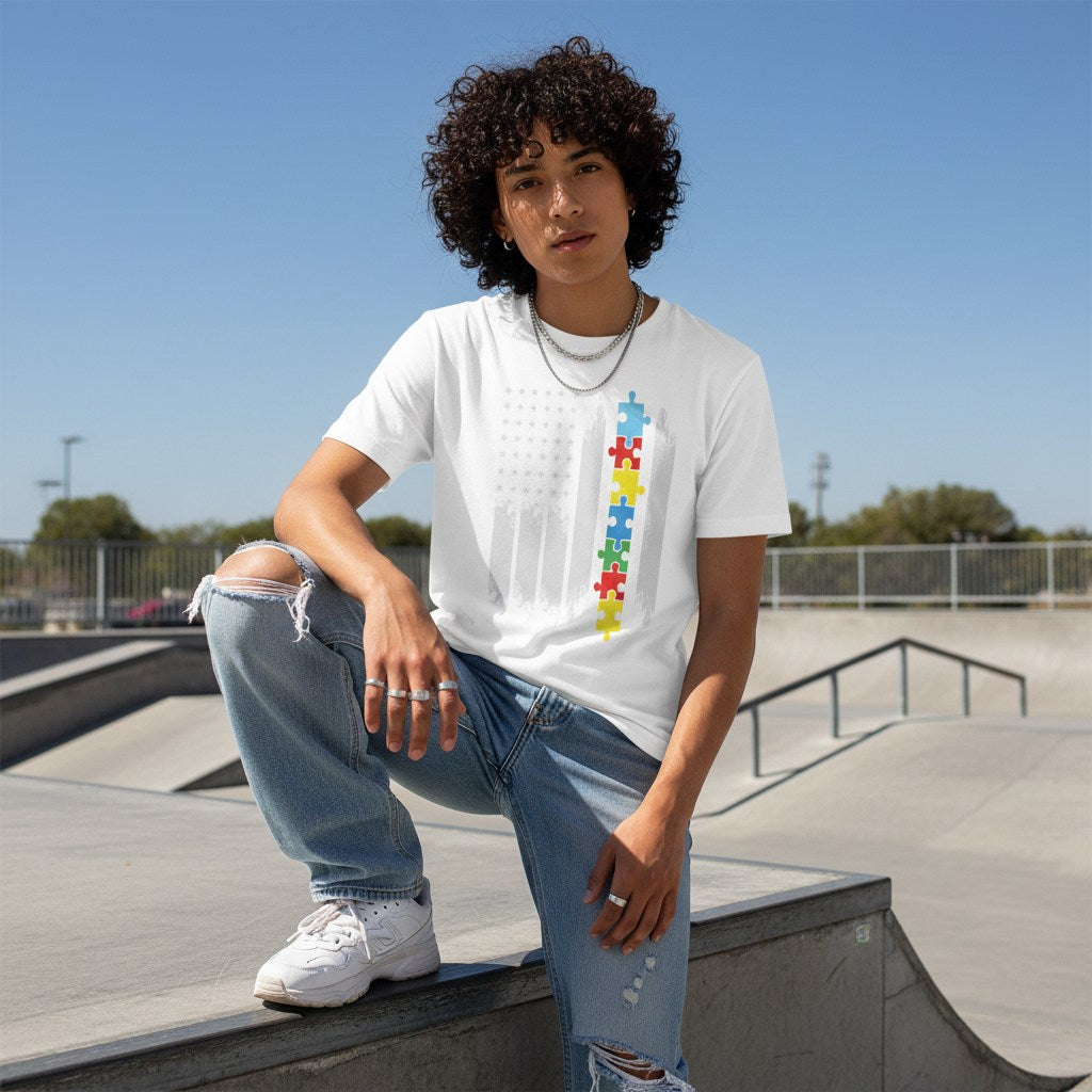 Middle Eastern non-binary person wearing a white autism flag T-shirt.