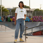 Middle Eastern non-binary person wearing a white autism awareness t-shirt.