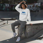 Middle Eastern non-binary person wearing a white "In April We Wear Blue" autism awareness sweatshirt.