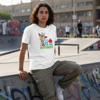 Middle Eastern non-binary person wearing a white t-shirt with an its ok to be different giraffe design.