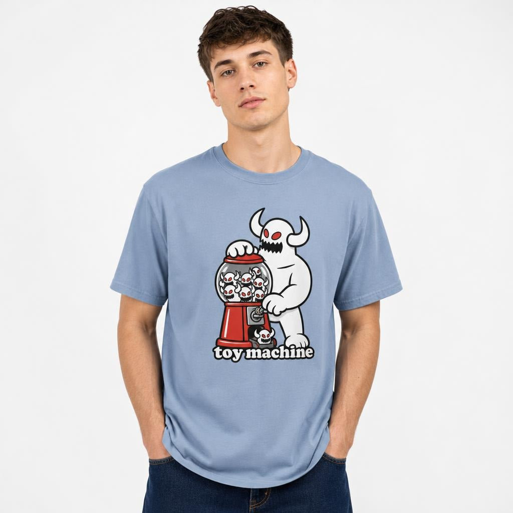 Front view of a Washed Denim T-shirt featuring a horned white monster operating a red skull-filled gumball machine.