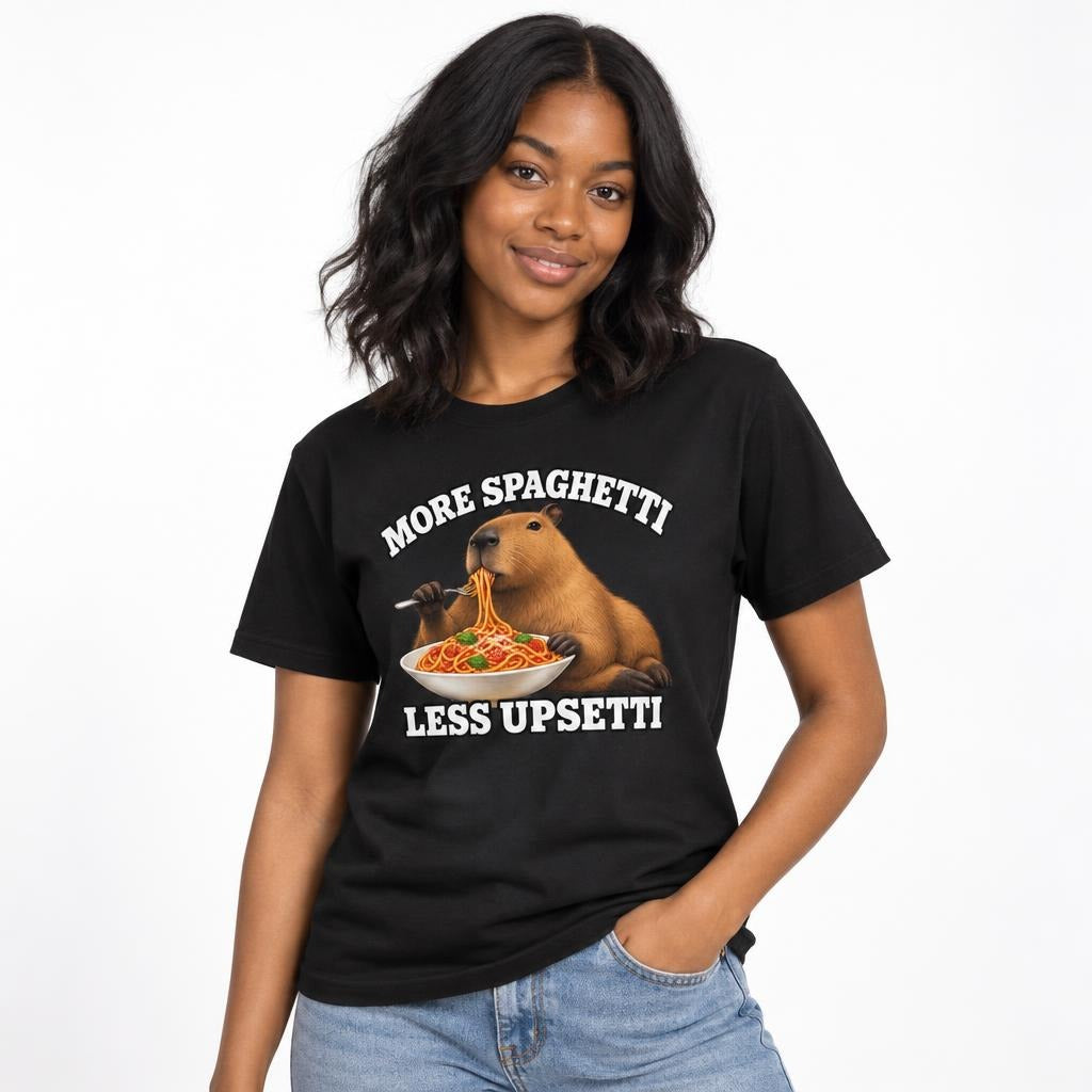 Model wearing a black T-shirt with a capybara eating spaghetti, framed by the text “MORE SPAGHETTI LESS UPSETTI.”