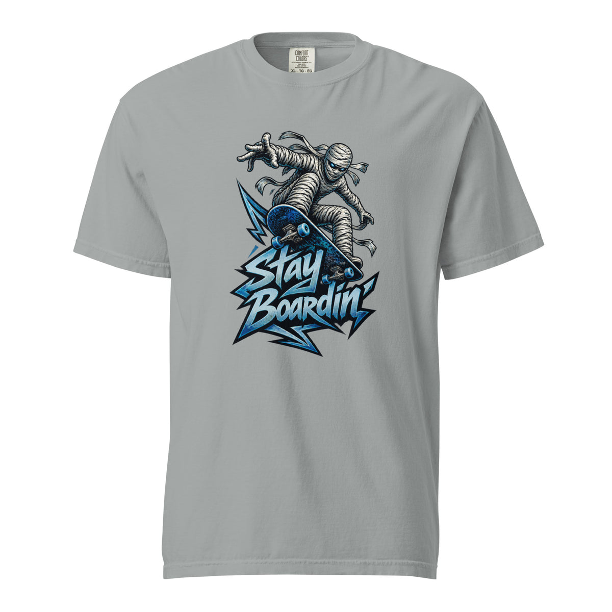 Front of a Granite T-Shirt featuring a bandage-wrapped mummy riding a blue skateboard above bold “STAY BOARDIN’” lettering.