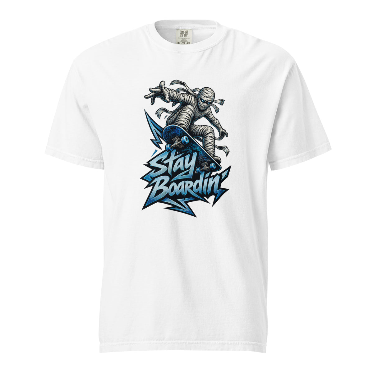 White T-Shirt featuring a bandage-wrapped mummy riding a blue skateboard above bold “STAY BOARDIN’” lettering and angular blue accents.