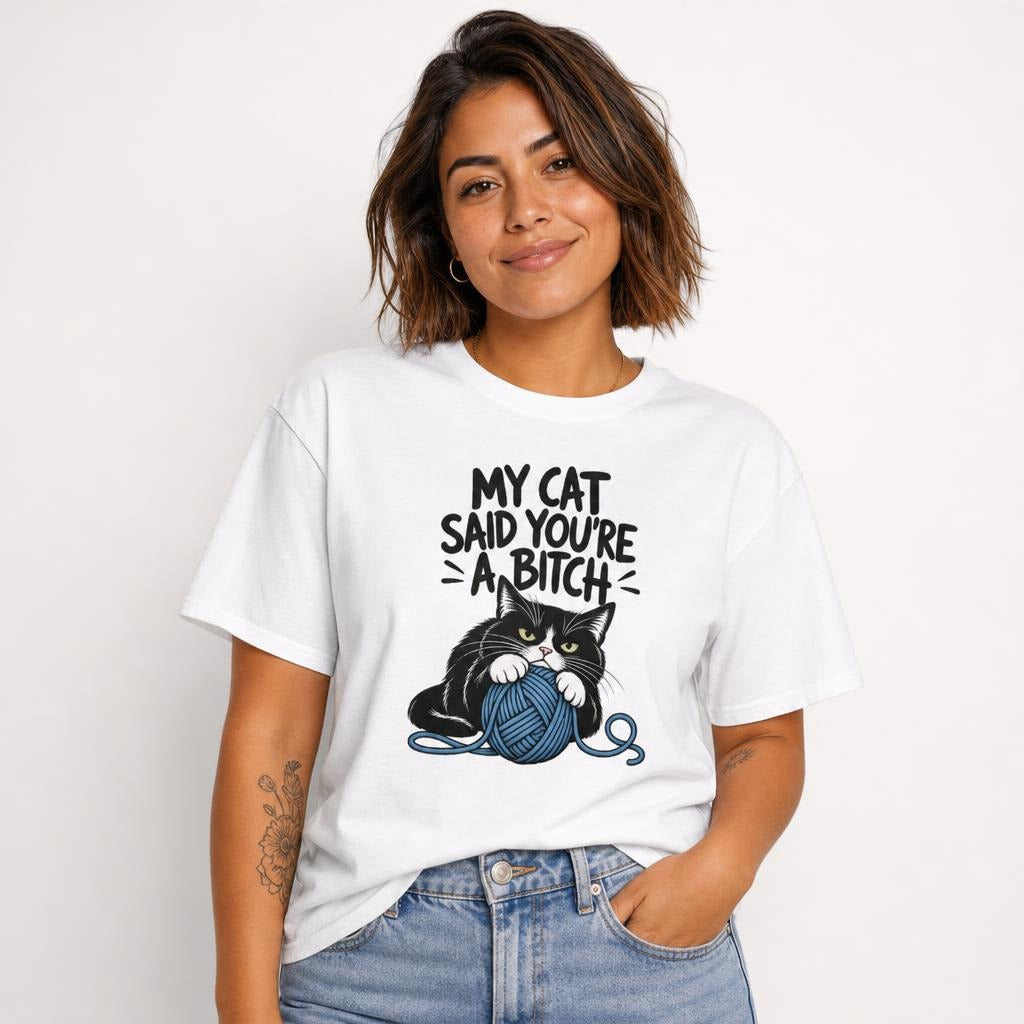 Front view of a model wearing a white T-shirt with “MY CAT SAID YOU’RE A BITCH” above a black-and-white cat clutching a blue yarn ball.