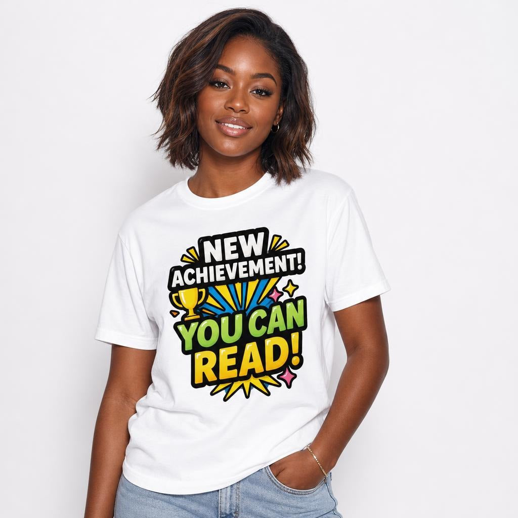Model wearing a white T-shirt with a colourful trophy design and motivational text reading “NEW ACHIEVEMENT! YOU CAN READ!”