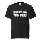 Front view of a black T-shirt with bold distressed typography reading “NOBODY CARES WORK HARDER,” expressing sarcastic work humour.