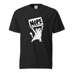 Front view of a black T-shirt featuring a black-and-white cartoon cat holding a rectangular sign reading “NOPE”.