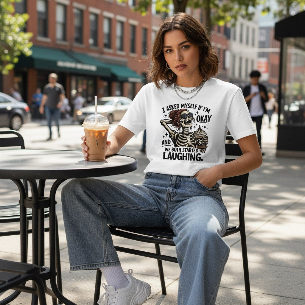 Lifestyle shot of a person wearing a white t-shirt at an outdoor cafe.