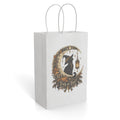 White paper gift bag featuring an ornate Halloween illustration of a black cat, pumpkins, a lantern, and “Trick or Treat” lettering.