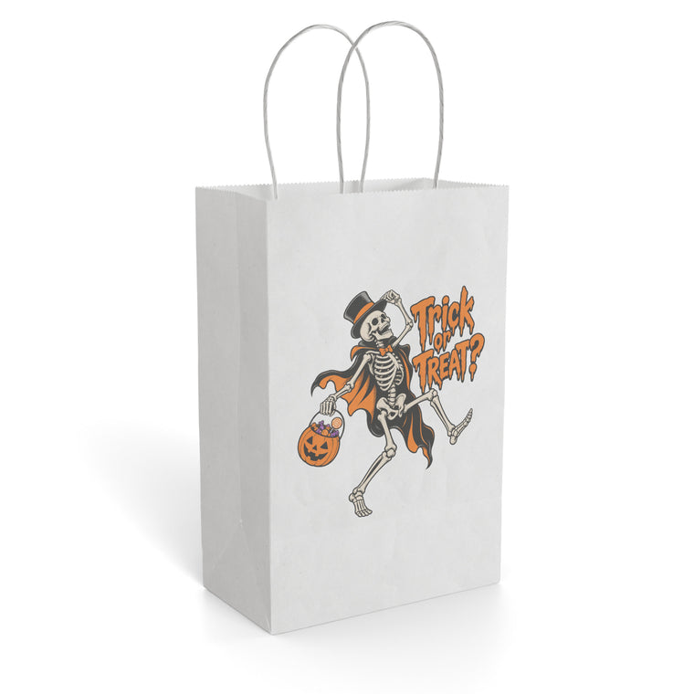 White paper gift bag with twisted handles, showing a top-hatted dancing skeleton in an orange cape holding a pumpkin treat bucket beside “Trick or Treat?” text