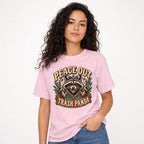 Peace Out Trash Panda Raccoon t shirt in Blossom worn by a studio model in an upper-body three quarter left pose on a clean white background