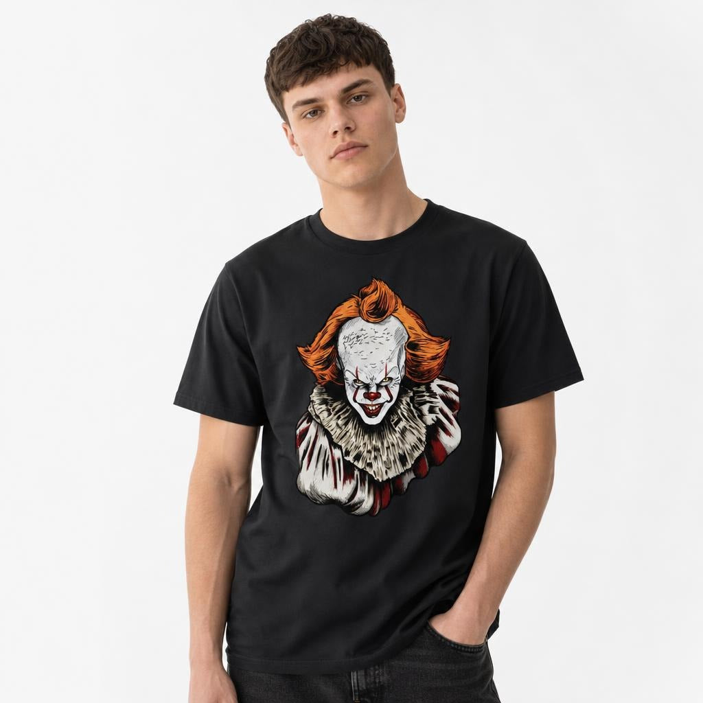 Model wearing a Black T-Shirt featuring a sinister illustrated clown with orange hair, red nose, sharp teeth and a ruffled costume.