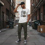 South Asian man wearing a white "If My Personalities Offend You" skeleton girl t-shirt in an urban streetwear setting.