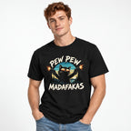 Model wearing a Black T-Shirt with a cartoon cat in sunglasses firing two pistols, framed by “PEW PEW” and “MADAFAKAS”.