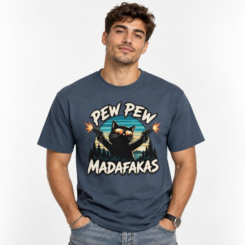 Model wearing a Midnight T-shirt with a black cat in sunglasses firing two pistols, framed by “PEW PEW” and “MADAFAKAS” lettering.