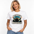 Model wearing a White T-Shirt featuring a black cat in sunglasses firing two pistols, framed by “PEW PEW” and “MADAFAKAS” lettering.