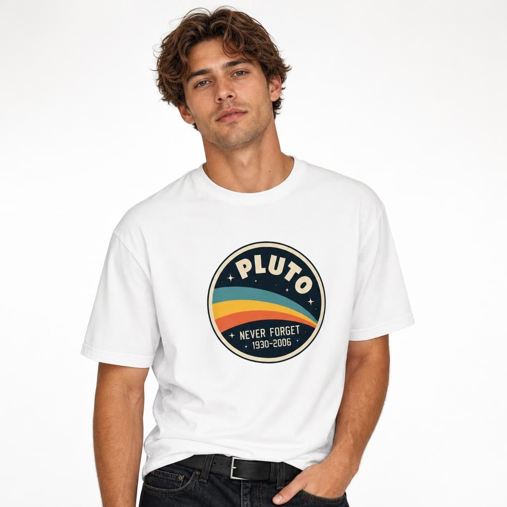 Model wearing a white T-shirt with a circular Pluto graphic, colourful sweeping bands, stars, and “NEVER FORGET 1930–2006” text.