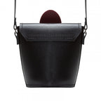 Black leather handbag with a strap on a white background