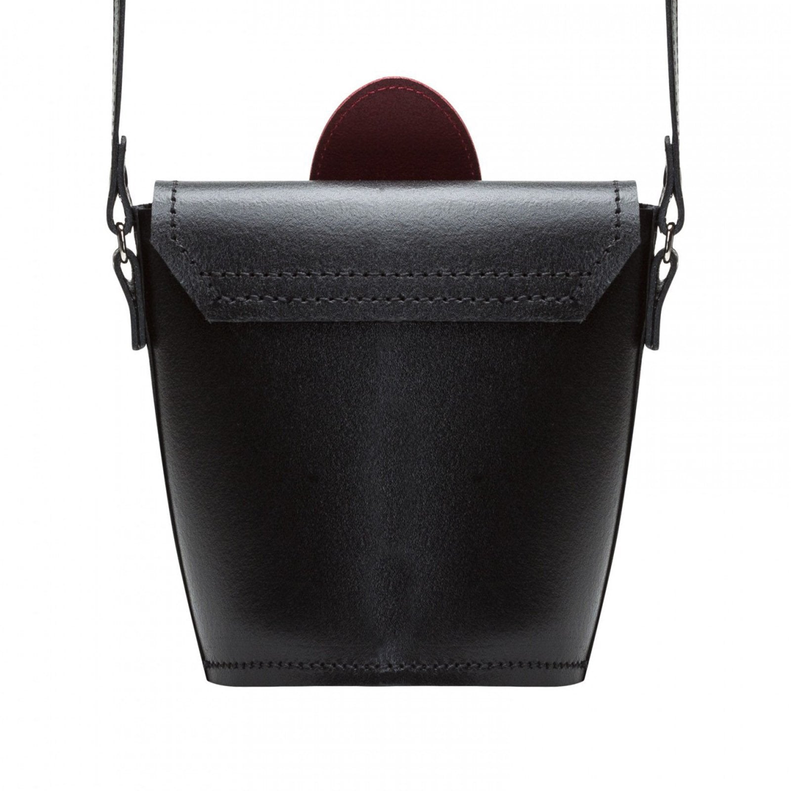 Black leather handbag with a strap on a white background