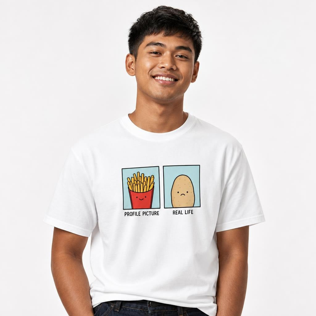 Front view of a white T-shirt with a two-panel cartoon of smiling French fries and a sad potato labeled “PROFILE PICTURE” and “REAL LIFE”.