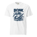Front view of a white T-shirt featuring a leaping ram colliding with a crocodile amid splashing water, with “BONK” above.