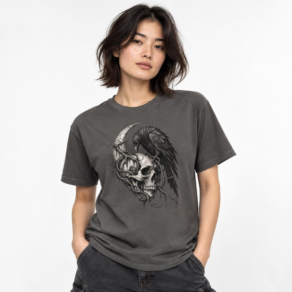 Front view of a Pepper T-shirt featuring a detailed monochrome skull, raven, and crescent moon graphic.