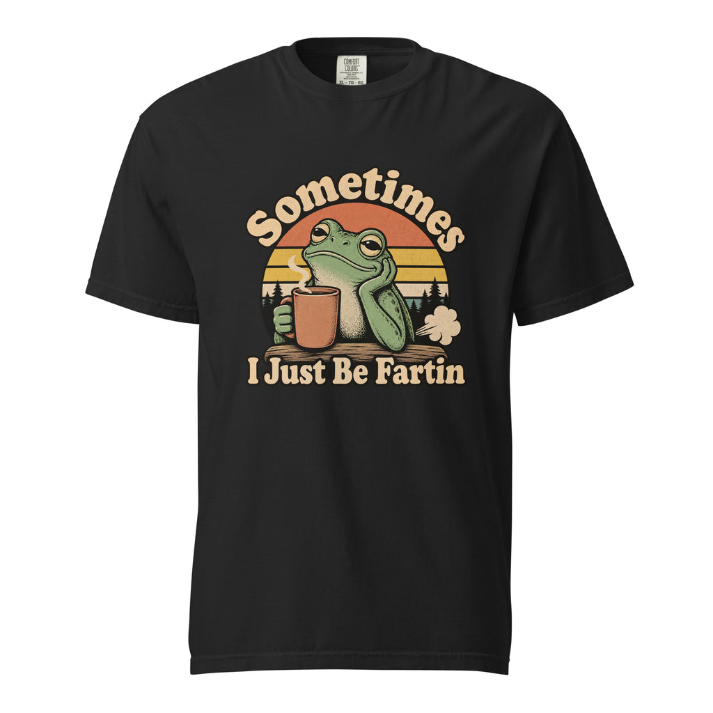 Front view of a black T-shirt with “Sometimes I Just Be Fartin,” featuring a frog holding a steaming coffee cup before a striped sunset.