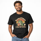 Model wearing a black T-shirt with “Sometimes I Just Be Fartin,” featuring a frog holding a steaming coffee cup at sunset.