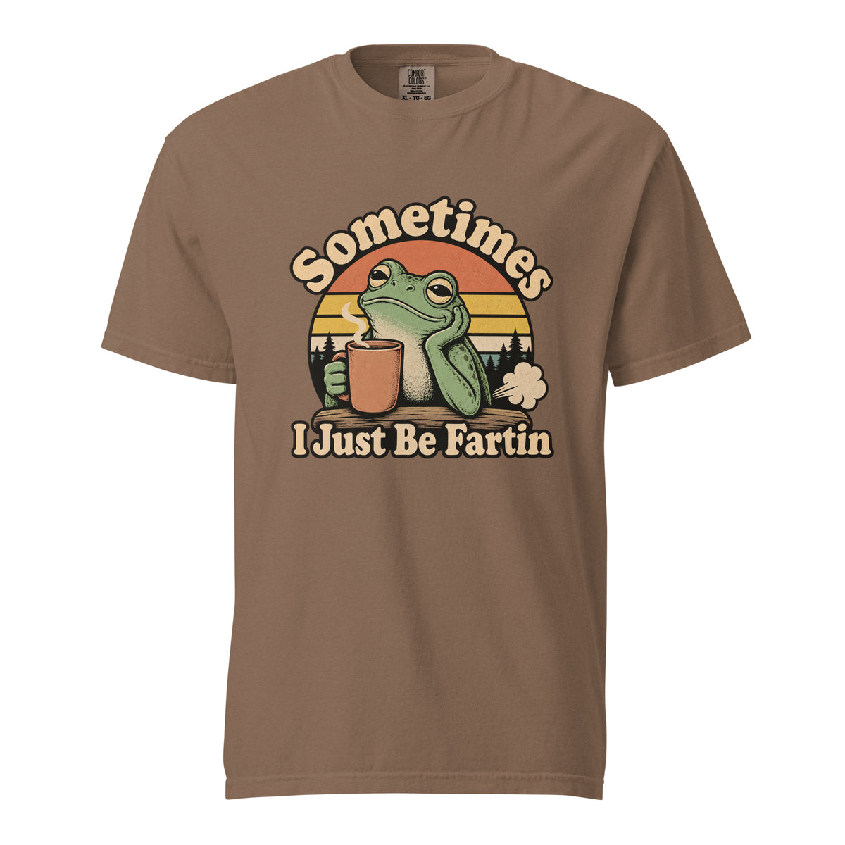 Front view of an Espresso T-shirt with “Sometimes I Just Be Fartin” lettering, a green frog holding a steaming coffee cup, and a sunset backdrop.