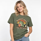 Model wearing a moss T-shirt with “Sometimes I Just Be Fartin” text, featuring a frog holding a steaming coffee cup.
