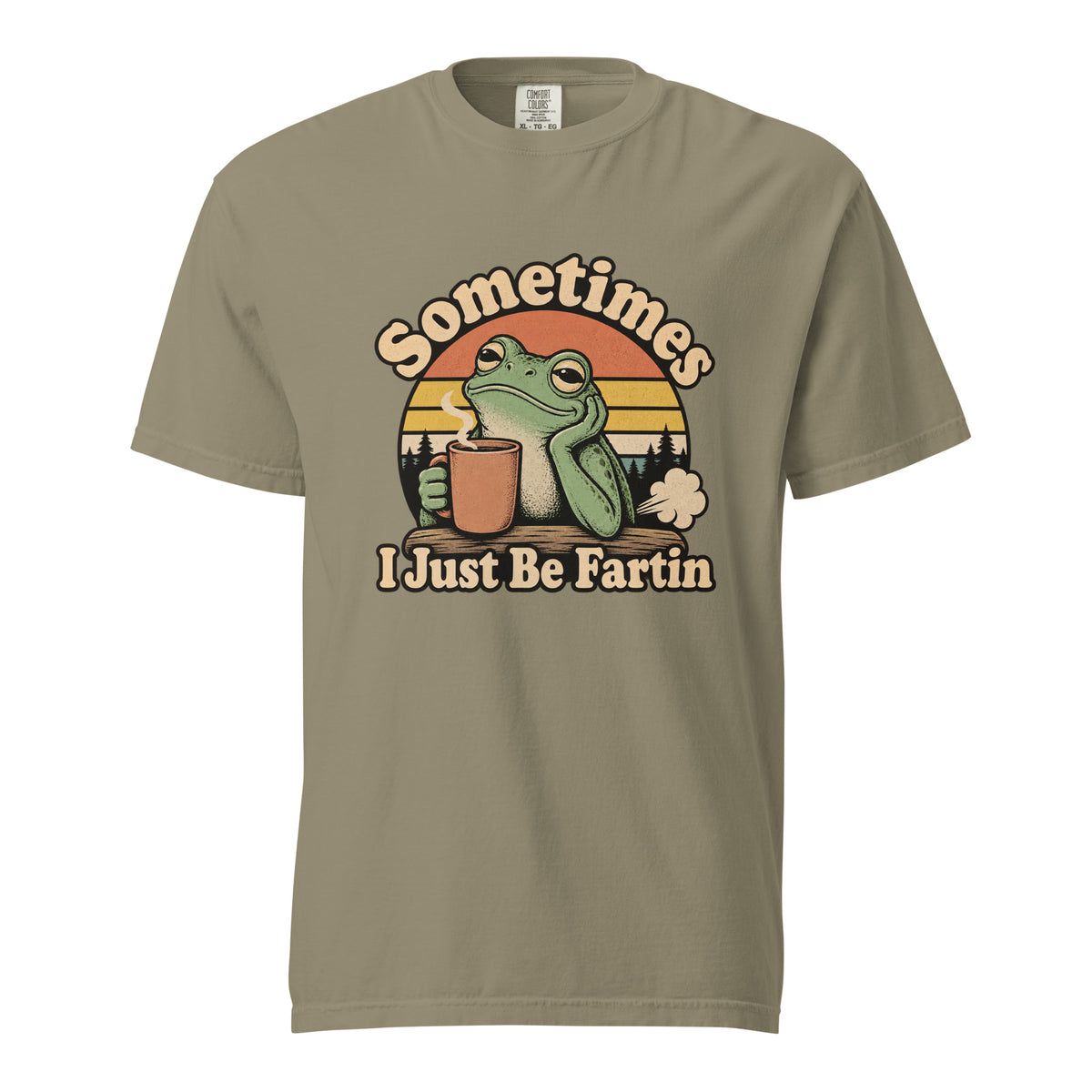 Front view of a Sandstone T-shirt with “Sometimes I Just Be Fartin” lettering, a green frog holding a steaming coffee cup, and a striped sunset.