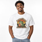 Front view of a white T-shirt with “Sometimes I Just Be Fartin” lettering, a frog holding a steaming coffee cup, and a sunset design.