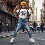 South Asian girl wearing a white autism superpower dinosaur t-shirt.
